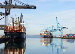 Barges with containers in industrial shipyard